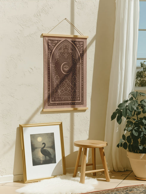A large, luxurious tapestry in muted mauve and brown, featuring a Gothic arch design. In the center, a crescent moon holds an All-Seeing Eye that radiates light. The design is filled with intricate patterns like quatrefoils and stars, creating a mystical, esoteric feel. The fabric has a subtle damask texture and is hung from wooden dowels. This piece is suitable as spiritual wall art, a witchy altar cloth, or dark academia decor, blending celestial and gothic aesthetics.